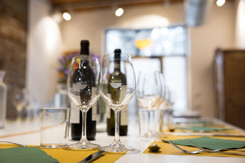 bottles of wine on table with wine glasses