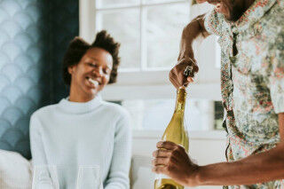 tagAlt.Happy couple opening wine Black Power 2