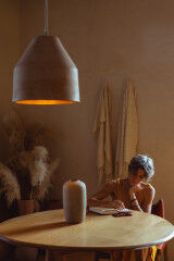 tagAlt.Woman writing at table 5